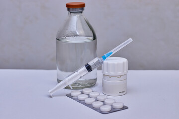 Syringe, pills and bottle. The vaccination of people. Preventive vaccination.