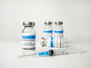Ampoules with the Covid-19 vaccine and a syringe for vaccination, immunization and treatment of coronavirus infection. The concept of healthcare and medicine
