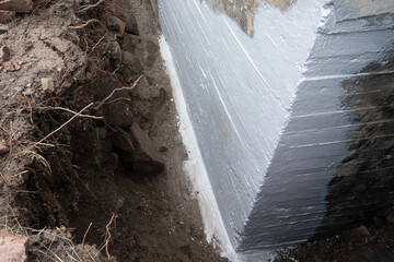 Waterproofing foundation of an old house.
