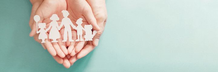 hands holding paper family cutout, family home, foster care, homeless support, social distancing,...
