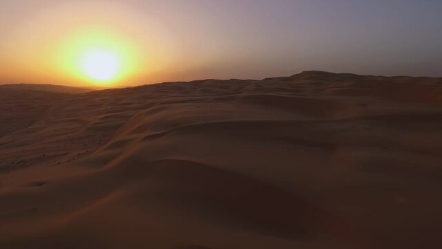 Liwa oasis sandy sunset desert patterned Moreeb dune landscape aerial view slow fly over