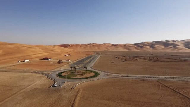 Liwa oasis empty partially finished roundabout in sandy red desert extreme terrain Abu Dhabi aerial view