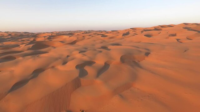 Liwa oasis patterned barren sandy Abu Dhabi Moreeb dune desert landscape aerial slow push in