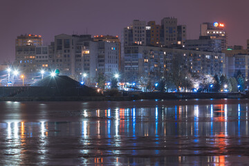 Fototapeta na wymiar Beautiful city at night. Night city reflected in the water.