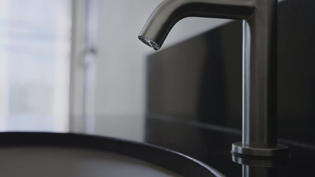 Close up wash basin water drop in bathroom, Stainless steel water tap or  vale have water drop,Slow motion water dope chrome faucet in the toilet,Concept save energy and protect environment