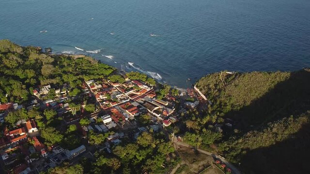 Aerial shot of Puerto Colombia and El Malec&oacute;n, Aragua State, Venezuela, high angle backward shot