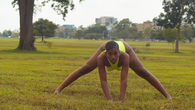 Natural hair model pose for the camera while wearing a bikini with the city of Port of Spain in the background
