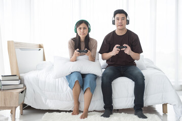 A couple having fun playing video games in the room.
