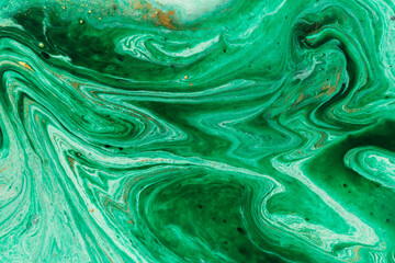 Green marble abstract acrylic background. Marbling artwork texture. Agate ripple pattern. Gold powder.