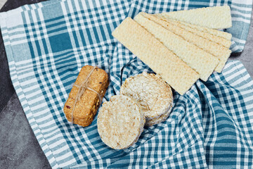Assorted crackers on a marble background with a tablecloth