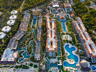 Aerial drone view of beach resort hotels with pools, umbrellas and blue water of Atlantic Ocean,...