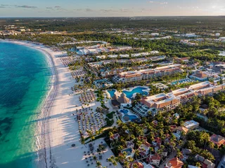 Foto op Plexiglas Aerial drone view of beach resort hotels with pools, umbrellas and blue water of Atlantic Ocean, Bavaro, Punta Cana, Dominican Republic © Pavel