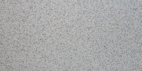 Fototapeta premium decorative plaster with black and grey grains, closeup panoramic texture