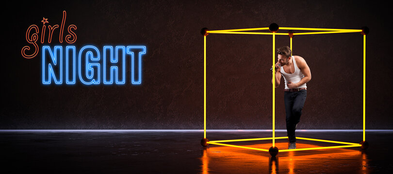singer dancing in an neon cube light installation next to the text GIRLS NIGHT on concrete floor