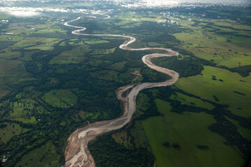 Aerial view of river in with humid forests around it. Colombia