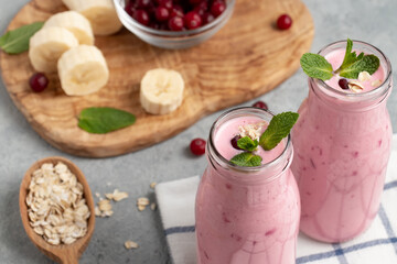 Homemade yogurt smoothie with banana, cranberry and oatmeal