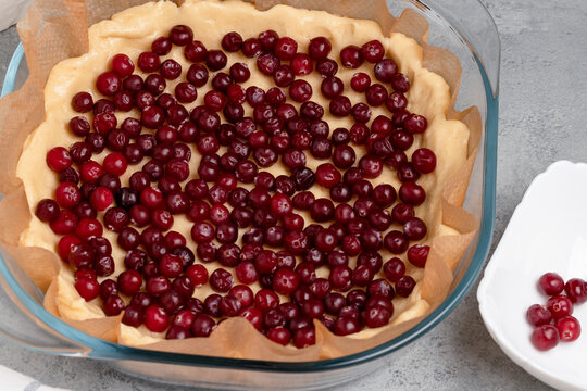 Homemade baking. Making a sweet cranberry pie in a glass baking dish