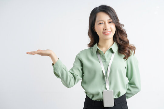 Portrait of a beautiful Asian businesswoman pointing to the side