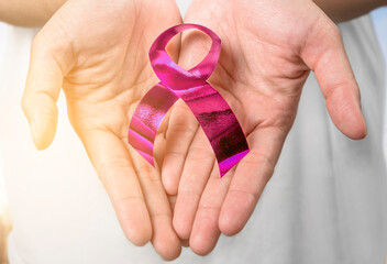 Human hand showing purple ribbon