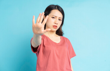 Fototapeta premium The beautiful Asian woman was holding her hand out in front of her to ask not to come any closer