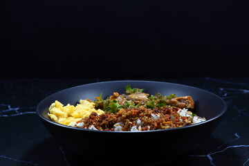 Classic cooked jasmine rice topping with crispy fish paste serving on the plate. Famous comfortable food menu in Asia. 