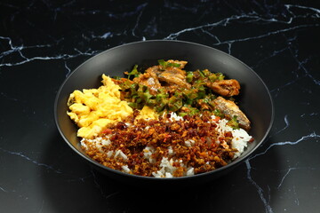 Classic cooked jasmine rice topping with crispy fish paste serving on the plate. Famous comfortable food menu in Asia. 