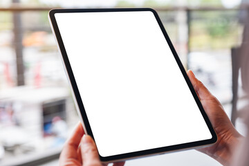 Mockup image of a woman holding digital tablet with blank white desktop screen
