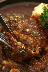 Cross section of hamburger with demi-glace sauce cut in half. close up