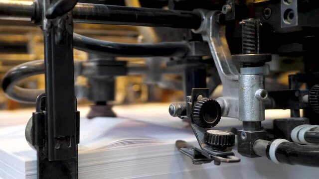 Printing machine print paper in typography. Newspaper or tabloid print on plant factory, conveyor belt line after printing