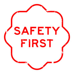 Grunge red safety first word rubber seal stamp on white background