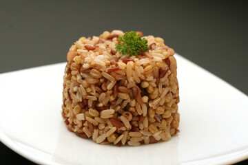 White rice on a plate, spoon on the side