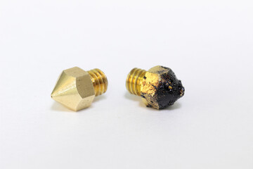New and used brass nozzles for 3d printer on white background