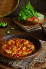 a plate of prawn cooked in sambal in an earhenware plate named gami udang is an Indonesian cuisine from Bontang, Borneo.