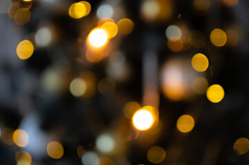 Colorful defocused bokeh lights in blur night background. Abstract Blurry Background Bokeh, mix green, brown, gold colors
