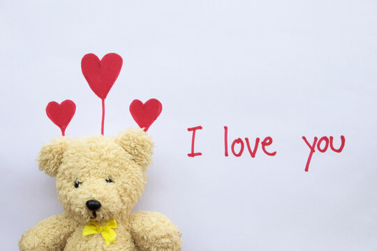 i love you message card handwriting with red heart draw in valentine and teddy bear on paper white