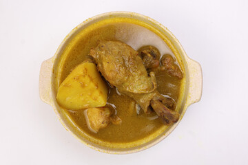 South east Asian curry chicken in ceramic bowl over white background