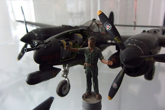 PIESTANY, SK - OCTOBER 10, 2020: Model of Lockheed P-38 Lighting, single seated piston-engine american fighter aircraft during World War II. Model figure of army mechanic on fuel barrel in front. 