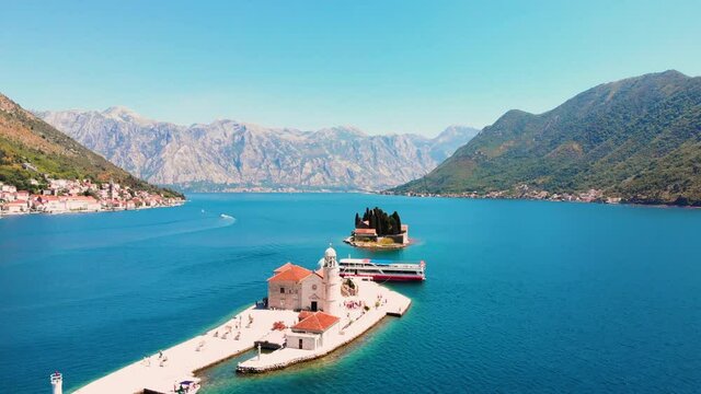 Perast, Bay of Kotor, Montenegro. Drone flying over the Our Lady of the Rocks. The island Saint George on the background. 4K Video