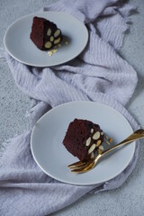 slice of chocolate cake in a plate in grey background