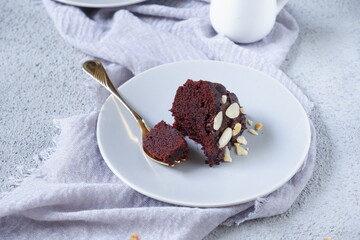 slice of chocolate cake in a plate in grey background
