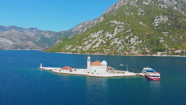 Perast, Bay of Kotor, Montenegro. Drone flying over the Our Lady of the Rocks. The island Saint George on the background. 4K Video