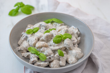 home made gnocchi with mushrooms and arugula