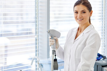 doctor woman with electric device in hands, using modern equipment for treatment in hospital