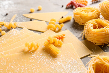 Assortment of dry pasta on grunge background