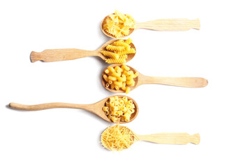 Spoons with assortment of dry pasta on white background