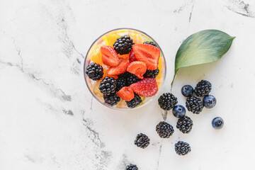 Bowl with fruit salad on light background