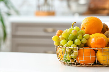 Basket with different fruits on kitchen table