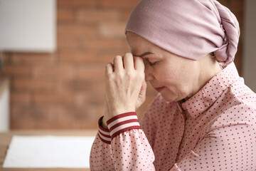 Sad mature woman after chemotherapy at home