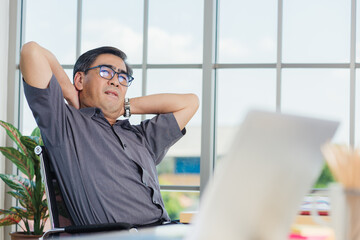 Asian hard senior businessman working with laptop computer has a problem with neck pain. Old man feeling pain after sitting at desk long time, Healthcare and medicine office syndrome concept
