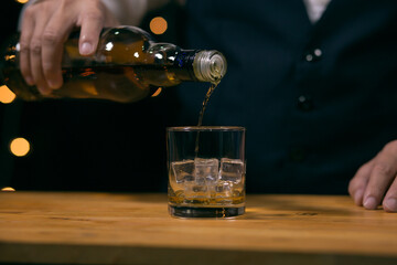Barman pouring whiskey whiskey glass beautiful night